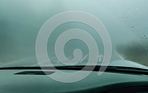 View through the cars windshield in the winter fog on the road