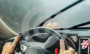 View through the cars windshield in the winter fog on the road