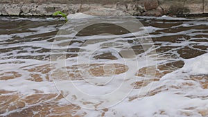 View of cascade of flowing river with fast flow in centrum city.