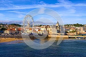 View of Cascais, Portugal, coastline and beach with Ferris wheel on sunny day