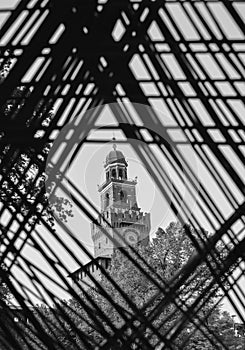 View of the Castello Sforzesco in Milan, Italy on a frame of intelocking cords on the foreground.