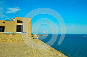 View from the Castillo de Santa BÃ¡rbara to the Mediterranean Sea in front of Alicante. On the castle wall sits a seagull looking