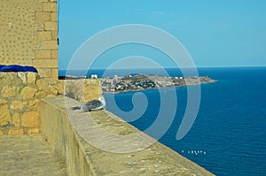 View from the Castillo de Santa BÃ¡rbara to the Mediterranean Sea in front of Alicante. On the castle wall sits a seagull looking