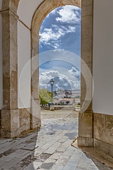 View of the castle and fortress of Obidos, between arches pillars of Lord Jesus of the Stone Sanctuary