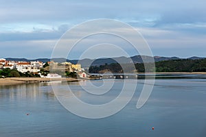 View of the castle and village of Milfontes andthe Mira River photo