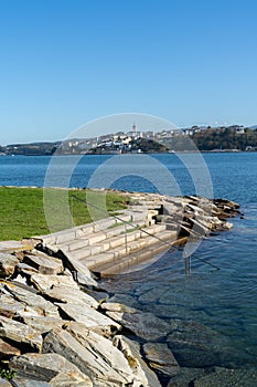View of Castropol in Asturias across the Ribadeo River with the Praia dos Bloques in the foreground photo