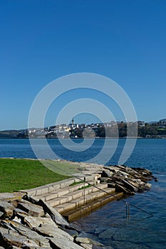 View of Castropol in Asturias across the Ribadeo River with the Praia dos Bloques in the foreground photo