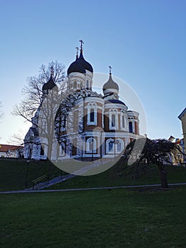 View of the Cathedral of the Holy Prince Alexander Nevsky against the blue sky and the Commandant`s Garden