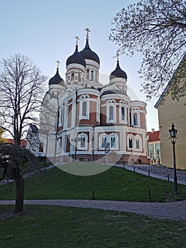 View of the Cathedral of the Holy Prince Alexander Nevsky against the blue sky and the Commandant`s Garden