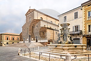 View at the Cathedral of Saint Peter the Apostle and fountain at the Liberty place in Faenza - Italy