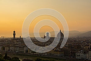 View of the Cathedral of Santa Maria del Fiore Duomo and Arnolfo tower of Palazzo Vecchio. Amazing evening golden hour light.