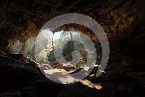 view of cave with natural light filtering in, illuminating the spelunking formations