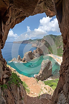 A view of a cave with an ocean and rocks in the background, AI