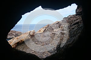 View from the cave to the sea and the rocky coast, Spain