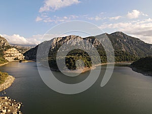 View of the Cedrino Lake - Lago del Cedrino, surrounded by the mountain range in Sardinia, Italy.