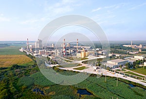 View of the cement plant with pipes. Industrial factory with smoke frow pipe. Chimney smokestack emission. Ð¡ement production