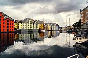 View of center of Alesund, Norway during a cloudy day with reflection