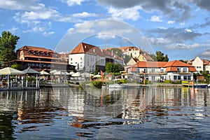 View of the center of Ryn, the castle, the lake and the marina with moored boats. Masuria, Poland