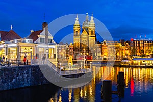 View from central station to Basilica of Saint Nicholas, Amsterdam, Netherlands, at night