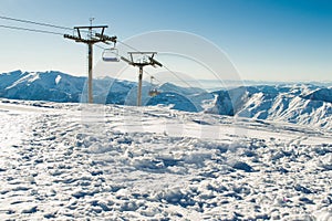 View chairlift at ski resort with mountain range on background. Extreme sport. Active holiday. Free time, travel concept. Copy spa