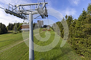 View of chairlift to the mountain with observation tower located at the top of the SÅ‚otwiny Arena ski station, Krynica Zdroj,