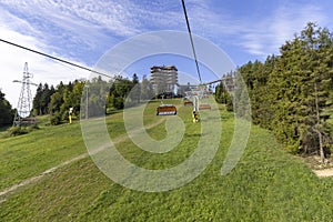 View of chairlift to the mountain with observation tower located at the top of the SÅ‚otwiny Arena ski station, Krynica Zdroj,