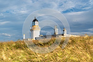 view of Chanonry Point Lighthouse at sunset in summer in Higlands of Scotland.