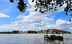 View of the Chao Phraya River with houses or pavilions flooded in river with blue sky and cloud background