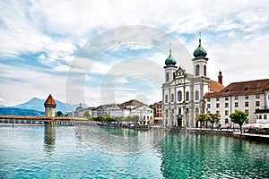 View at the Chapel bridge over Reuss river and Jesuit church in Luzern