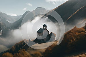 view of chapel surrounded by misty mountains and clouds