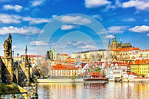 View of Charles Bridge, Prague Castle and Vltava river in Prague, Czech Republic.Nice sunny summer day with blue sky and clouds.