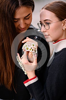 charming women with hands decorated with small daisy flowers