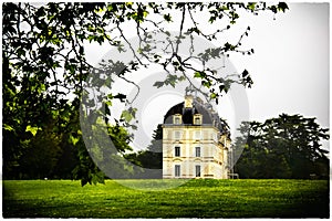 The view on Cheverny Castle, Loire valley, France . The view from afar through the branches