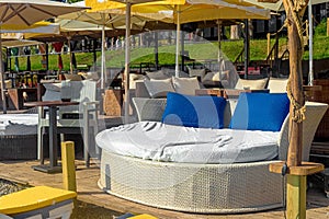 View of chic VIP chauffeurs in the form of a bed with blue pillows in a cafe on the seashore.