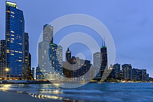 View of Chicago skyline form the shore of lake Michigan at twilight