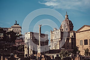 View of Chiesa Santi Luca e Martina martiri and Arco di Settimio Severo. Rome, Italy. Blue sky