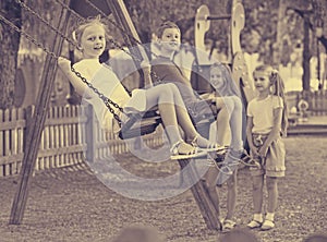 View on children swinging together on children's playground
