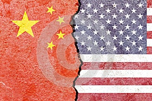 View of China VS USA national flags isolated on broken cracked concrete wall background