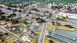 View of Chincoteague Island and the road along the bay. houses and motels with parking lots. View from above photo