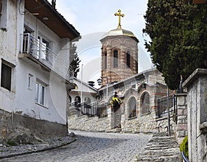 View of the church in the city of Ohrid while walking along the cozy streets with stone pavements near the city center, North