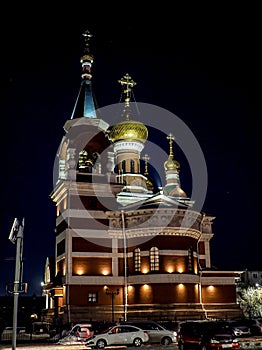 view of the church on a frosty winter night, the domes shine gold in the dark night sky