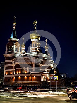 view of the church on a frosty winter night, the domes shine gold in the dark night sky