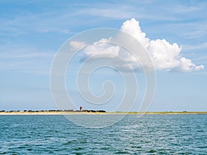 View of church of Hollum and coast of Ameland island in Waddensea, Friesland, Netherlands