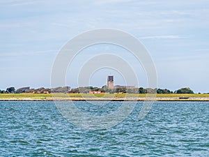 View of church of Hollum and coast of Ameland island in Waddensea, Friesland, Netherlands