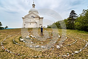 View of the church on the holy hill with a spiral of stones and a figure of a boy