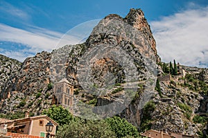 View of the church Notre-Dame de Beauvoir amid the cliffs and steeple of Moustiers-Sainte-Marie.