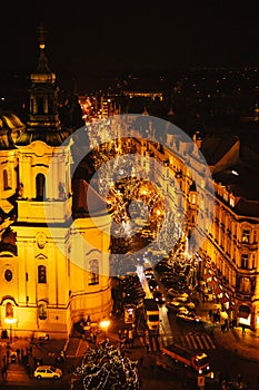 View of the Church of St. Nicholas and street. Night Christmas Decoration of Prague`s main square. Street, open area