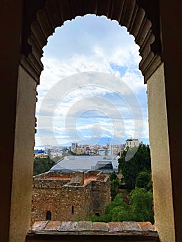 view of the city from the arch of Alcazaba de Malaga, cloudy day, Andalusia, Spain photo