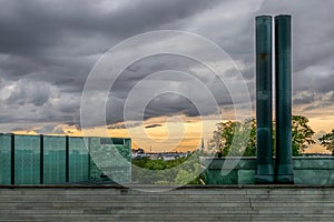 A view of city and church spire with a modern building