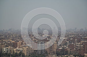 View on the city of Giza in a morning with smog, outskirts of Cairo, as seen from the Giza Plateau. Panoramic Shot Of Cityscape